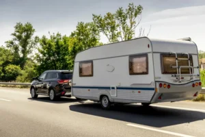 A black SUV carrying a with caravan