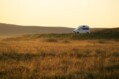 White,campervan,wild,camping,in,rural,countryside,in,golden,hour